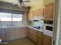 Functional kitchen with ample cabinet space, vintage appliances, and a bright window at 7637 E Thornwood Dr, Scottsdale, AZ 85251