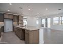 Open concept kitchen with a large island, modern faucet, and stainless steel appliances at 7956 W Griswold Rd, Peoria, AZ 85345