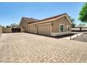 Spacious three-car garage with a paved driveway, offering ample parking and storage at 8031 W Morten Ave, Glendale, AZ 85303