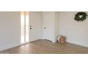 Bright entryway with new flooring and a white front door, creating an inviting first impression at 909 S Acapulco Ln # A, Tempe, AZ 85281