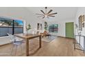 Stylish dining area with clear chairs, light floors and a sleek table for elegant meals at 1001 N Nielson St, Gilbert, AZ 85234