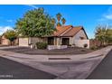 Well-manicured property with lush greenery, a tidy gravel yard, and an inviting facade at 1001 N Nielson St, Gilbert, AZ 85234