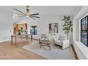 Bright and airy living room featuring modern furnishings, a ceiling fan, and ample natural light at 1001 N Nielson St, Gilbert, AZ 85234