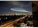 Stunning night view of the city skyline with a trail in the sky at 1040 E Osborn Rd # 501, Phoenix, AZ 85014