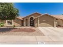Charming home with a well-manicured front yard and a symmetrical facade at 11206 W Sieno Pl, Avondale, AZ 85392