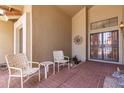 Inviting covered front porch with tiled flooring and decorative seating area at 11206 W Sieno Pl, Avondale, AZ 85392