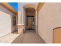 Front porch features stone flooring and a wood door, with a peek of the interior at 11312 E Enrose St, Mesa, AZ 85207