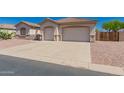 Charming single story home featuring a two car garage and desert landscaping at 11312 E Enrose St, Mesa, AZ 85207