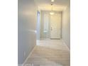 Inviting hallway with tile floors and neutral paint, leading to the front door at 1241 E Palo Verde Dr, Casa Grande, AZ 85122