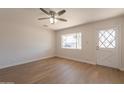 Bright living room boasts a ceiling fan and a glass-paned front door for ample natural light at 1310 E Ironwood Dr, Buckeye, AZ 85326