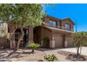 Beautifully landscaped front yard of a brown two story home with desert landscaping at 1405 E Aloe Dr, Chandler, AZ 85286