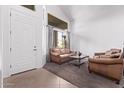 Bright living room featuring high ceilings, a large window, neutral colors, and comfortable seating at 1405 E Aloe Dr, Chandler, AZ 85286