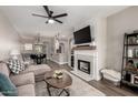 Open floor plan featuring stylish living room with fireplace and view to dining area and kitchen at 1411 E Orangewood Ave # 233, Phoenix, AZ 85020