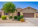 Welcoming single-story home with a two-car garage and drought-tolerant landscaping at 15862 W Fillmore St, Goodyear, AZ 85338