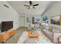 Bright living room featuring neutral decor, a ceiling fan, and large windows with a view at 1739 E Carter Rd, Phoenix, AZ 85042