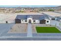 Aerial view showcasing the home's modern design, gray tile roof, professional landscaping, and desert surroundings at 2005 W Lincoln Ct, Queen Creek, AZ 85144