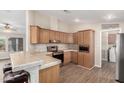 Efficient kitchen with wooden cabinets, stainless steel appliances, and a breakfast bar at 201 S Greenfield Rd # 29, Mesa, AZ 85206