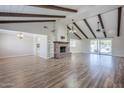 Spacious living room with wood floors, brick fireplace, and sliding glass doors at 2178 E Golf Ave, Tempe, AZ 85282