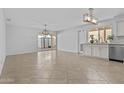 Open-concept living area with tile floors and sliding glass doors to the backyard at 2313 N 87Th Way, Scottsdale, AZ 85257