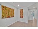Bright room with wood floors and white walls offers versatile space for living or home office at 242 N Crosscreek Dr, Chandler, AZ 85225