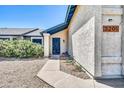 Entrance to a home featuring a blue security door and low-maintenance desert landscaping at 3201 W Mohawk Ln, Phoenix, AZ 85027