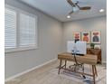 Bright office space with plantation shutters, wood desk, and accent decor at 3411 E Louise Dr, Phoenix, AZ 85050