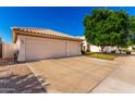 Wide driveway leading to a three-car garage, offering ample parking space and convenience for residents at 3412 E Kristal Way, Phoenix, AZ 85050