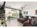 Cozy living room featuring a large sectional sofa, light wood floors, and a sliding glass door to the backyard at 3415 S 75Th Dr, Phoenix, AZ 85043