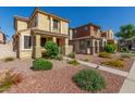 Lovely two-story home with desert landscaping, a welcoming porch, and a clear blue sky at 5 N 87Th Ln, Tolleson, AZ 85353