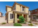 Charming stucco home featuring desert landscaping, covered porch, and a balcony detail at 5 N 87Th Ln, Tolleson, AZ 85353