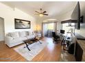 Bright living room with hardwood floors, fireplace, and balcony access at 5335 E Shea Blvd # 2081, Scottsdale, AZ 85254