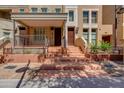 Townhome featuring an inviting front porch with multiple stairs up to the entrance at 581 S Roosevelt St, Tempe, AZ 85281