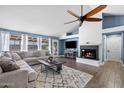 Bright living room with a cozy fireplace, vaulted ceilings, large sectional sofa, and views to the backyard at 5841 W Kesler St, Chandler, AZ 85226