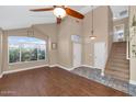 Bright living room with hardwood floors, a ceiling fan, and a view of the front yard at 8599 W Athens St, Peoria, AZ 85382