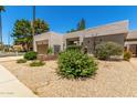 Eye-level shot of attractive single-story home with desert landscaping and an attached two-car garage at 9389 N 87Th Way, Scottsdale, AZ 85258