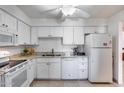 Well-lit kitchen featuring white cabinets, granite countertops and stainless steel appliances at 9450 N 94Th Pl # 116, Scottsdale, AZ 85258