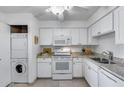 The kitchen boasts ample storage, granite countertops, and modern appliances, including washer and dryer at 9450 N 94Th Pl # 116, Scottsdale, AZ 85258