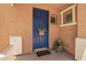 Charming covered entry with a blue front door, decorative basket, and 'Welcome Home' mat at 963 S Colonial Dr, Gilbert, AZ 85296