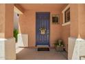An inviting blue front door featuring a welcome mat and covered porch at 963 S Colonial Dr, Gilbert, AZ 85296