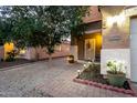 Close-up of home's front entrance with a decorated walkway and warm lighting at 12026 W Salter Dr, Sun City, AZ 85373