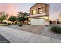 Charming home showcasing a landscaped front yard and brick driveway leading to a two-car garage at 12026 W Salter Dr, Sun City, AZ 85373