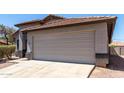 The front exterior showcases a neutral colored home with a two-car garage and desert landscaping at 1501 E Sunland Ave, Phoenix, AZ 85040