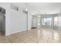 Bright living area features neutral paint, tile floors, and multiple windows for natural light at 1501 E Sunland Ave, Phoenix, AZ 85040