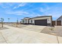 Charming single-story home with a two-car garage, desert landscaping, and modern architectural design at 15349 W Cottontail Ln, Surprise, AZ 85387