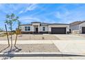 Inviting single-story home featuring desert landscaping, a two-car garage, and a welcoming entrance at 15349 W Cottontail Ln, Surprise, AZ 85387