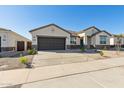 Attractive single-story home boasting low-maintenance desert landscaping and an attached two-car garage at 15357 W Cottontail Ln, Surprise, AZ 85387