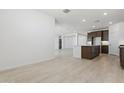 Spacious living area boasts tile flooring, white walls, and recessed lighting at 15365 W Cottontail Ln, Surprise, AZ 85387