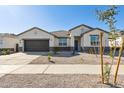 Inviting single-story home with desert landscaping, covered entry and a two-car garage at 15402 W Cottontail Ln, Surprise, AZ 85387