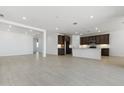 Bright and airy living room with modern tile flooring and an open-concept design at 15429 W Cottontail Ln, Surprise, AZ 85387