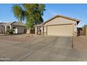 Charming single-story home with neutral palette, low maintenance desert landscaping, and two car garage at 1673 S 171St Dr, Goodyear, AZ 85338